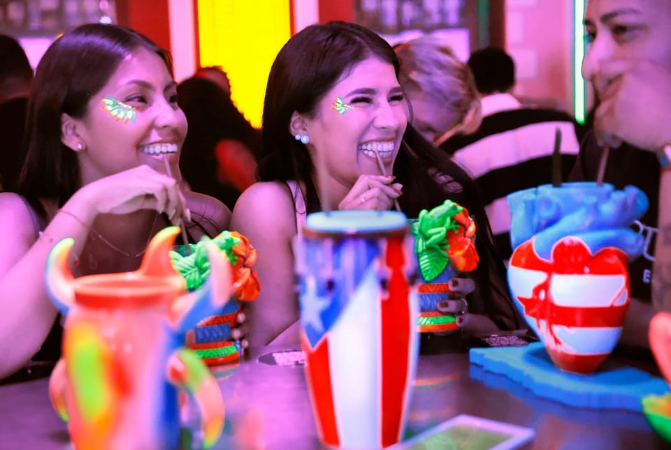 People dancing salsa and reggaeton in a lively bar, with colourful lights and a vibrant atmosphere, reflecting Puerto Rican '