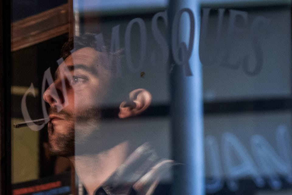 Actor reflected in the window of Can Mosques, the fictional restaurant in Ravalejar, the HBO Max series based on the Can Lluis eviction