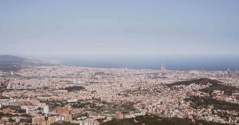 Aerial view of Barcelona's coastline, showing beaches, promenades, and urban areas stretching from Barceloneta towards Sant A