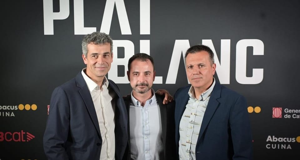 Three chefs, Oriol Castro, Eduard Xatruch, and Mateu Casañas, standing proudly in a professional kitchen, possibly at Disfrut