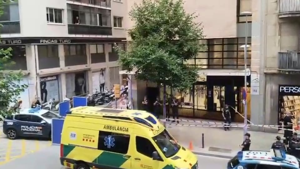 Police tape blocks off a street in Barcelona as officers investigate a crime scene.