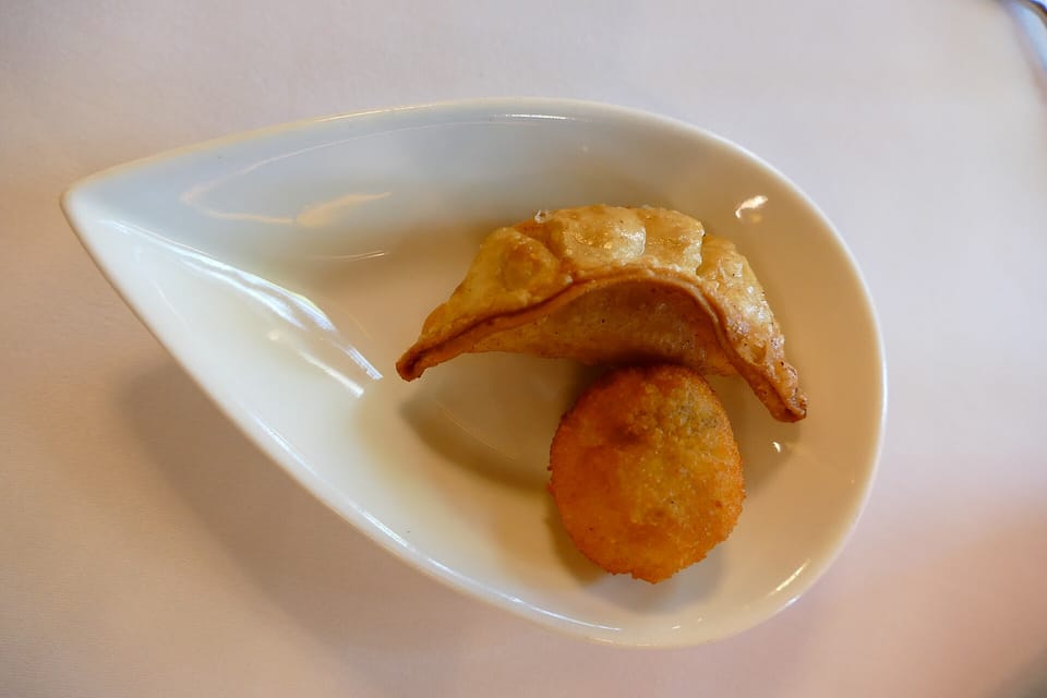 A plate of beautifully presented devilled eggs garnished with herbs and paprika, ready to be served in a Barcelona restaurant