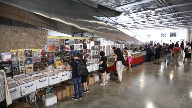 People browsing vinyl records at stalls inside the Fossat area of Sant Antoni Market in Barcelona