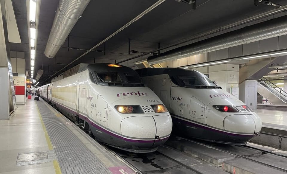 High-speed train on tracks with blurred background of countryside.