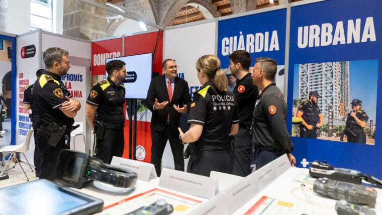 A Barcelona Urban Guard officer and a Barcelona firefighter stand together in uniform, representing the city's emergency serv