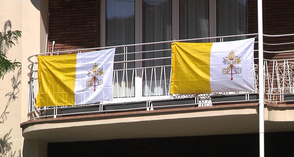 Vatican flags hang from balconies in Barcelona's Sarrià-Sant Gervasi district.