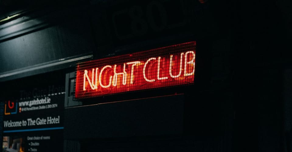Nightlife venues with closed shutters on a street in Barcelona's Poblenou district.